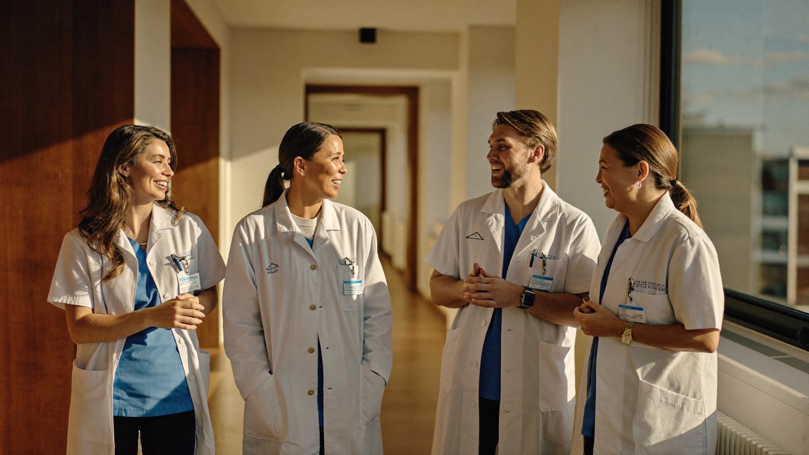 The Memory Treatment Centers clinical team talking in a bright clinic hallway